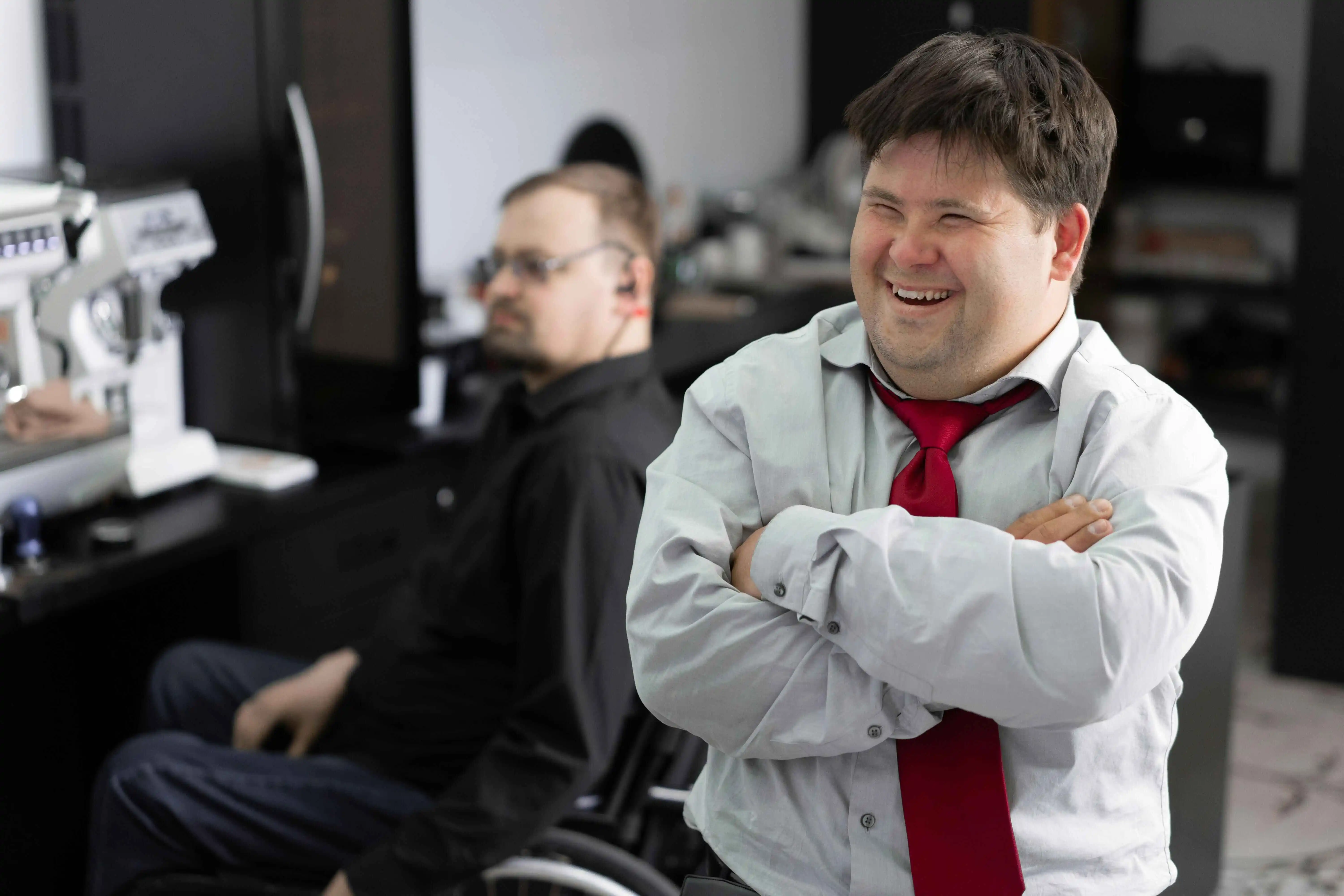 A disabled worker smiles in the workplace.